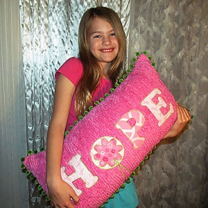 Hope-Pillow-hot-pink-front-with-girl.jpg